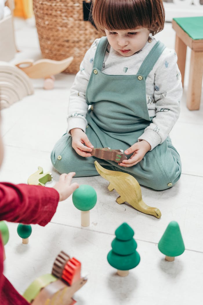 A young child playing with wooden toys indoors, showcasing creativity and fun.