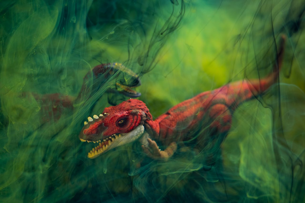 A vibrant dinosaur toy captured in a creative underwater ink photography setting with a green background.